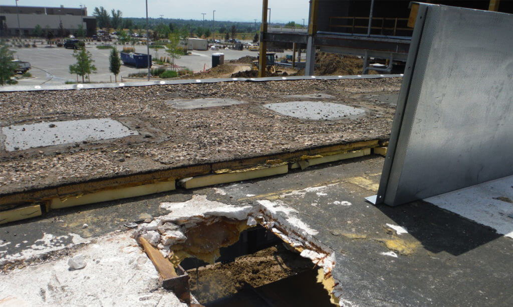 Hole in Roof of Commercial Building Due to Long-Term Water Intrusion