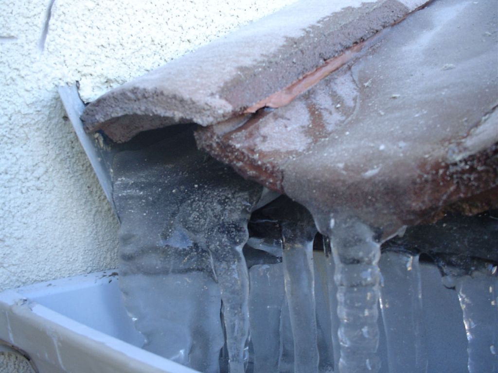Icicles on tile roof in gutter